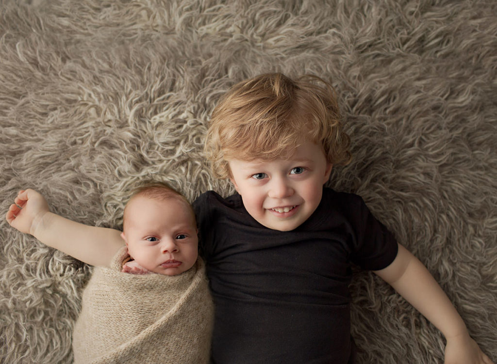 Big brother cuddling newborn brother  photography composite cuddle.