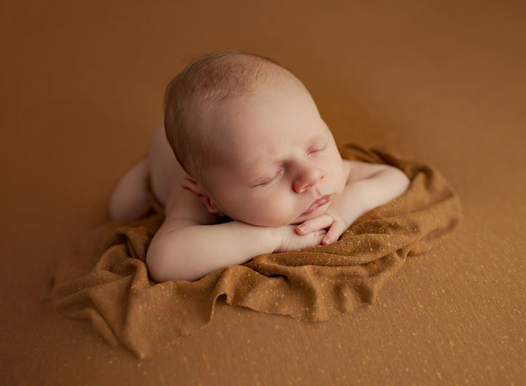 Backlit photo of newborn baby boy.